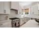 Well-equipped kitchen with stainless steel appliances, custom cabinetry, and a stylish range hood at 1505 Rivertowne Country Club Dr, Mount Pleasant, SC 29466