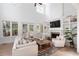 Spacious living room with a fireplace, built-in shelving, and soaring ceilings, perfect for relaxing at 1505 Rivertowne Country Club Dr, Mount Pleasant, SC 29466