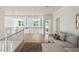Bright and open living area with white railings, hardwood floors, coffered ceiling, and a comfortable sofa, ideal for relaxing at 1505 Rivertowne Country Club Dr, Mount Pleasant, SC 29466