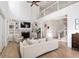 Open-concept living room featuring a fireplace, built-in shelves, and soaring ceilings at 1505 Rivertowne Country Club Dr, Mount Pleasant, SC 29466