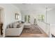 Inviting living area with a comfortable sectional sofa, balcony access, and hardwood floors, perfect for entertaining or relaxing at 1505 Rivertowne Country Club Dr, Mount Pleasant, SC 29466
