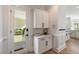 Convenient mudroom with cabinets, countertop, and a door leading to the backyard at 1505 Rivertowne Country Club Dr, Mount Pleasant, SC 29466