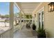 Inviting porch featuring rocking chairs, potted plants, and classic exterior lighting fixtures at 1505 Rivertowne Country Club Dr, Mount Pleasant, SC 29466