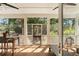 Inviting screened porch featuring wood floors and views of lush greenery at 1505 Rivertowne Country Club Dr, Mount Pleasant, SC 29466