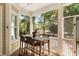 Charming porch with dining table and peaceful views of the surrounding landscape at 1505 Rivertowne Country Club Dr, Mount Pleasant, SC 29466