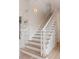 Elegant staircase features white wood trim, wood treads, and light walls at 1505 Rivertowne Country Club Dr, Mount Pleasant, SC 29466