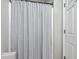 Neutral bathroom featuring a shower with a striped curtain and a white door at 1507 Blaze Ln, Charleston, SC 29412