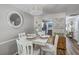 Bright dining area featuring a white table and chairs, wood floors that opens to the kitchen at 1507 Blaze Ln, Charleston, SC 29412