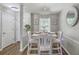 Bright dining area featuring a white table and chairs, wood floors and a modern light fixture at 1507 Blaze Ln, Charleston, SC 29412
