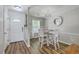 Bright dining area featuring a white table and chairs, wood floors and a modern light fixture at 1507 Blaze Ln, Charleston, SC 29412