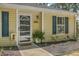 Close up view of the front of the home featuring yellow siding, blue shutters, front door with decorative glass at 1507 Blaze Ln, Charleston, SC 29412
