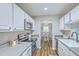 Well-lit kitchen featuring white cabinetry, stainless steel appliances, and a view into the adjacent dining area at 1507 Blaze Ln, Charleston, SC 29412