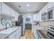 Eat-in kitchen featuring white cabinets, stainless steel appliances and view to living room at 1507 Blaze Ln, Charleston, SC 29412