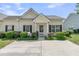 Inviting one-story home featuring a well-maintained front yard and neutral color palette at 157 Townsend Way, Summerville, SC 29483