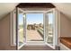 Attic window opened to a rooftop view of a deck, AC units and city skyline with blue skies at 17 Wentworth St, Charleston, SC 29401