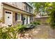 Charming brick home with a beautiful courtyard featuring a stone pathway and lush greenery at 17 Wentworth St, Charleston, SC 29401