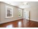 Bedroom with hardwood floors, windows, and white trim, and doorways to other rooms at 17 Wentworth St, Charleston, SC 29401