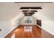 Bright bonus room with hardwood floors, exposed wood beams, and a window providing natural light at 17 Wentworth St, Charleston, SC 29401