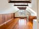 Bonus room featuring high ceilings, wood paneled walls, hardwood floors and a window to the outside at 17 Wentworth St, Charleston, SC 29401