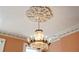 Close up of an ornate crystal chandelier and decorative crown molding in a formal living room at 17 Wentworth St, Charleston, SC 29401