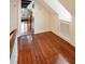 Hallway with hardwood floors, white walls, and trim, leading to another room, featuring a decorative window seat at 17 Wentworth St, Charleston, SC 29401