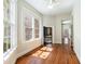 Light-filled living room featuring hardwood floors, and backyard views from the large windows at 17 Wentworth St, Charleston, SC 29401
