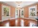 Bright living room with hardwood floors, chandelier, and large windows offering outdoor views at 17 Wentworth St, Charleston, SC 29401
