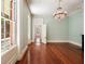 Light-filled room with hardwood floors, large windows, and an open doorway to adjoining room at 17 Wentworth St, Charleston, SC 29401