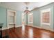 Sunlit formal living room with hardwood floors, a chandelier, and beautiful trim and molding at 17 Wentworth St, Charleston, SC 29401