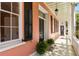 Inviting porch with black shutters, ferns, and a view of the charming architecture at 17 Wentworth St, Charleston, SC 29401