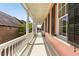 Long open porch showcasing the white columns and railings of this charming house with black shutters at 17 Wentworth St, Charleston, SC 29401