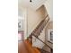 Staircase with carpet runner and white railing leading to a hallway and a window at 17 Wentworth St, Charleston, SC 29401