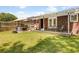Cozy backyard with a wooden deck, string lights, and a hot tub for outdoor relaxation at 1821 Wasp St, North Charleston, SC 29405