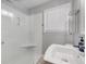 Bright bathroom with a white shower and a large window at 1821 Wasp St, North Charleston, SC 29405