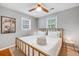Cozy bedroom with a brass bed frame, white linens, and dual windows at 1821 Wasp St, North Charleston, SC 29405