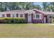 Charming brick home with a well-manicured lawn and mature landscaping at 1821 Wasp St, North Charleston, SC 29405
