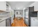 Bright kitchen that leads to dining area with white cabinets and countertops at 1821 Wasp St, North Charleston, SC 29405