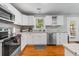 Well-lit kitchen with stainless steel appliances and white cabinets at 1821 Wasp St, North Charleston, SC 29405