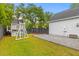 Spacious backyard with lush lawn, playset, and paved patio area at 2 Pagett St, Daniel Island, SC 29492