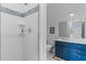 Bathroom featuring a glass shower, blue vanity and tile accents at 2 Pagett St, Daniel Island, SC 29492