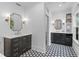 Elegant bathroom featuring dual vanities, black and white tile floors, and stylish mirrors at 2 Pagett St, Daniel Island, SC 29492