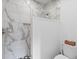 Modern bathroom featuring a glass-enclosed shower, marble tile, and sleek fixtures at 2 Pagett St, Daniel Island, SC 29492