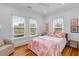 Bright bedroom with large windows, hardwood floors, and a cozy chair at 2 Pagett St, Daniel Island, SC 29492