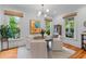 Cozy dining area with a rustic wooden table, modern chandelier, and bright, airy ambiance at 2 Pagett St, Daniel Island, SC 29492