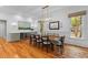Elegant dining room featuring hardwood floors, modern lighting, and a built-in wine storage unit at 2 Pagett St, Daniel Island, SC 29492