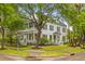 Beautiful two-story home with a front porch, manicured lawn, and mature trees at 2 Pagett St, Daniel Island, SC 29492