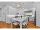 Well-lit kitchen showcasing the marble-topped island, pendant lighting, and stainless steel appliances at 2 Pagett St, Daniel Island, SC 29492