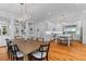 Spacious open-concept kitchen and dining room with stainless steel appliances and modern light fixtures at 2 Pagett St, Daniel Island, SC 29492