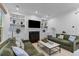 Bright living room with built-in shelving, a fireplace, and comfortable seating arrangement at 2 Pagett St, Daniel Island, SC 29492