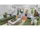 Open-concept living room with hardwood floors, stylish decor, and plenty of natural light at 2 Pagett St, Daniel Island, SC 29492